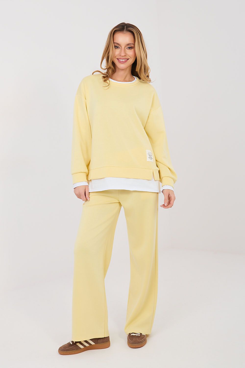 Woman wearing a yellow outfit with a white background