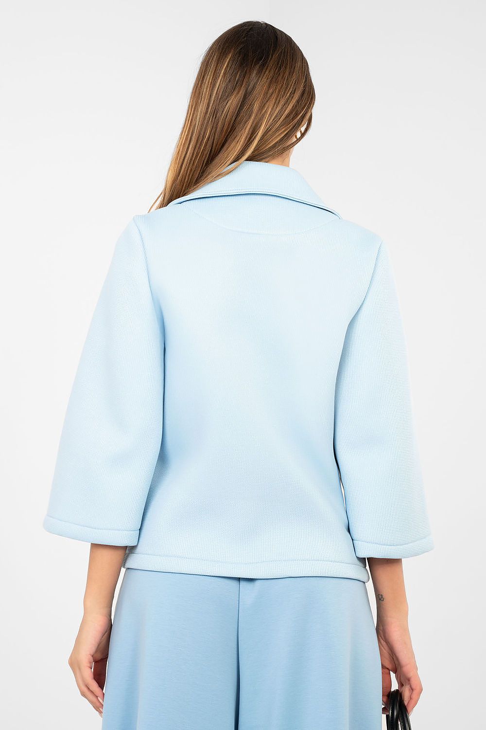 Light blue jacket worn by a person on a white background