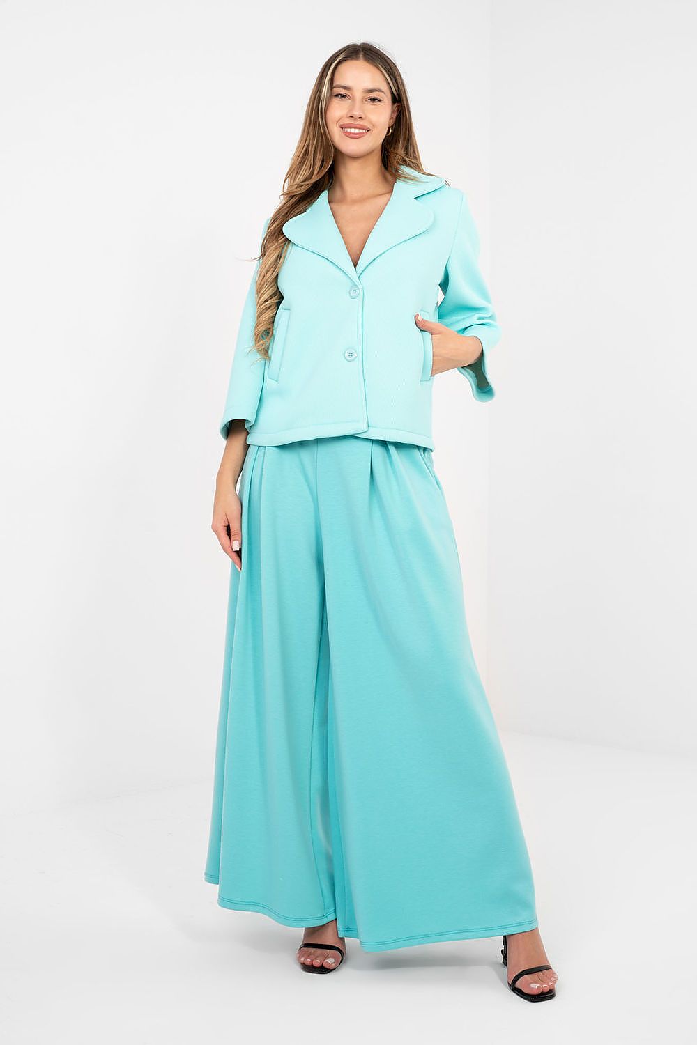 Woman wearing a light blue outfit on a white background