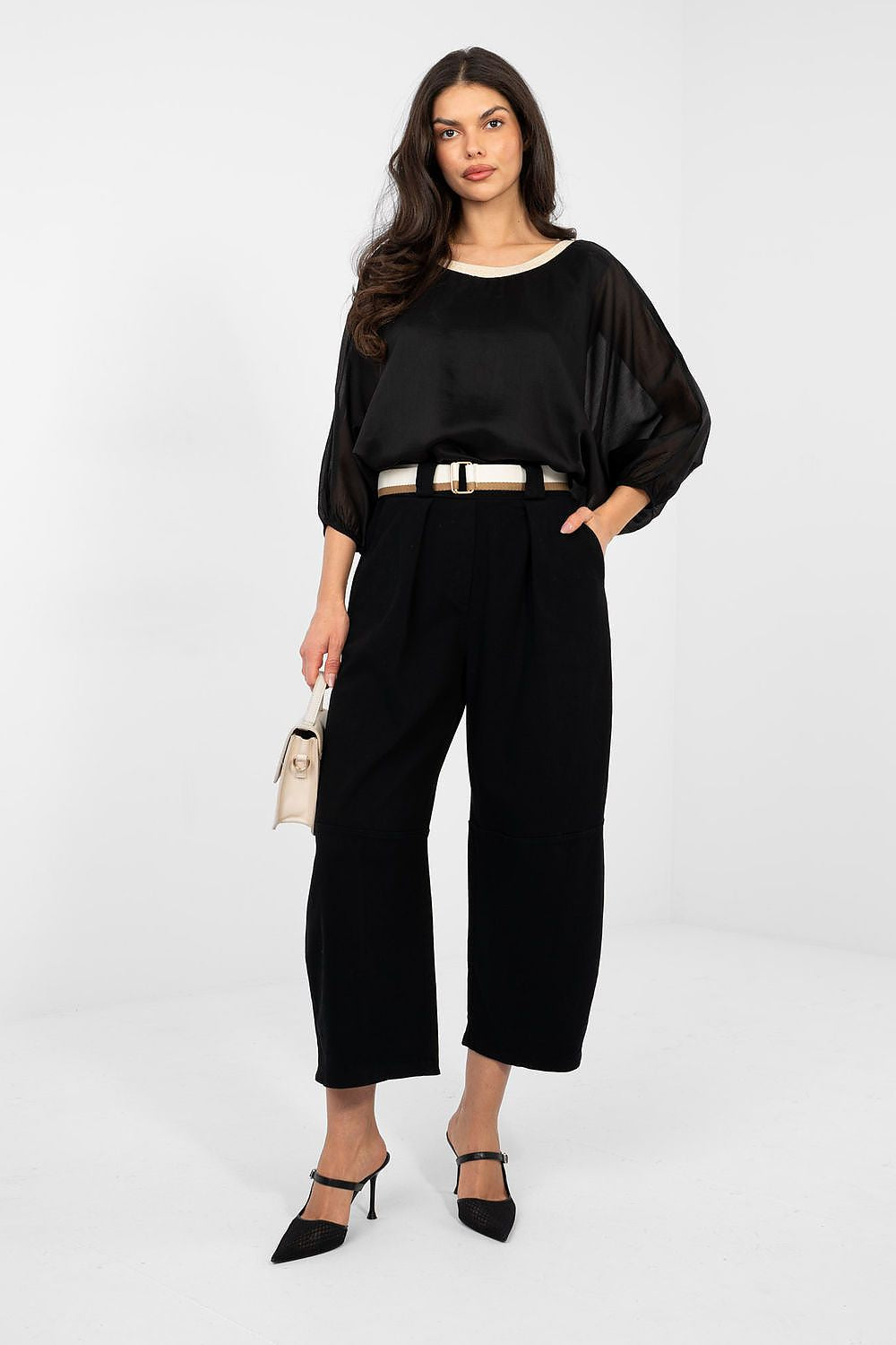 Woman wearing a black outfit with a white background