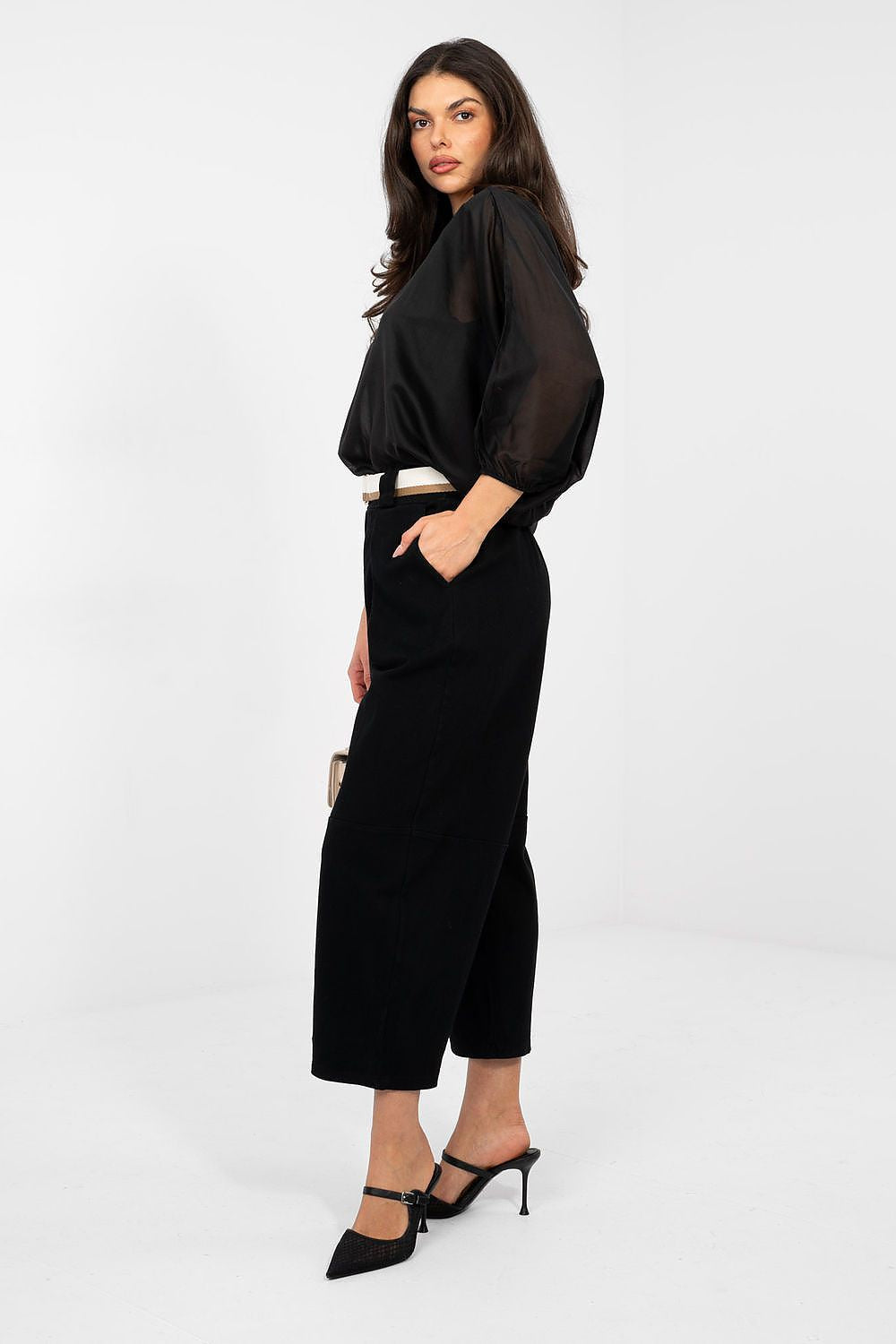 Woman wearing a black outfit with a white background