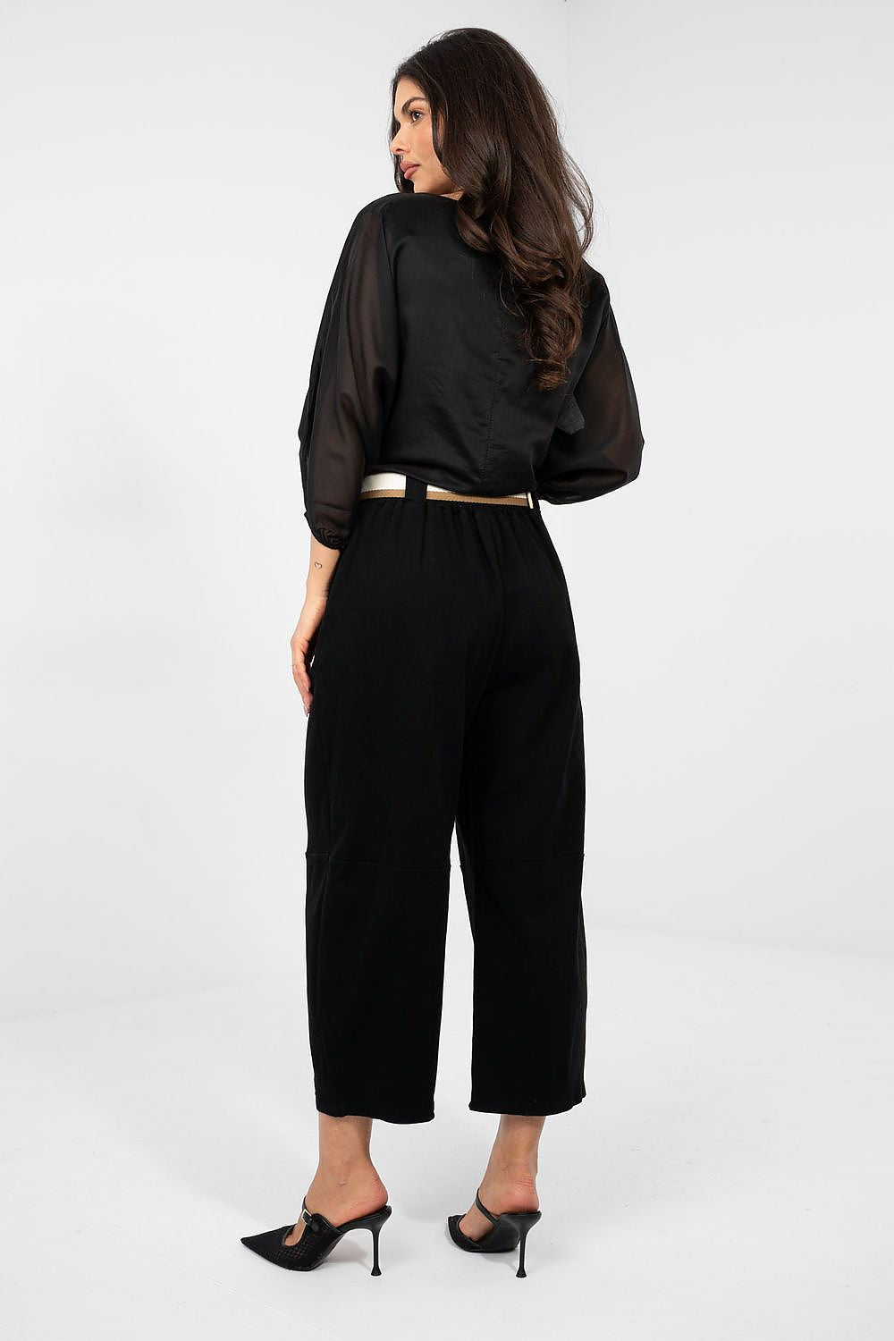 Woman wearing a black outfit on a white background