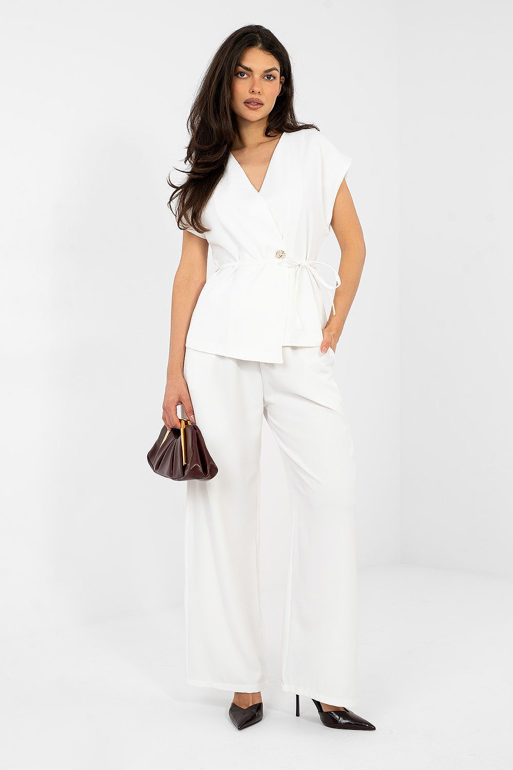 Woman wearing a white outfit with a plain background