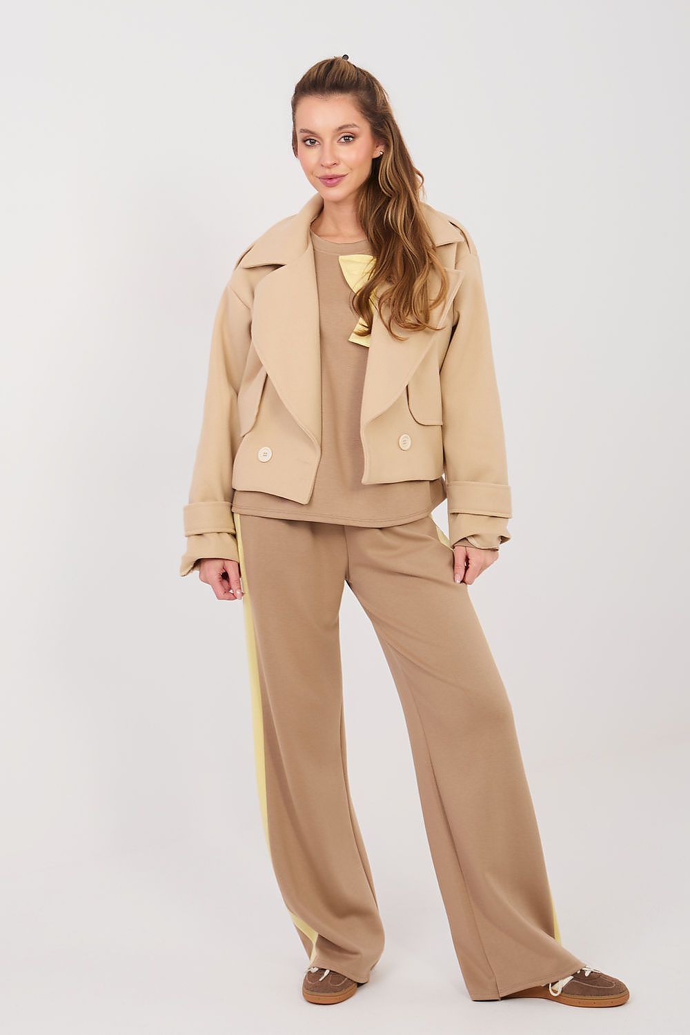 Woman wearing a beige outfit on a white background