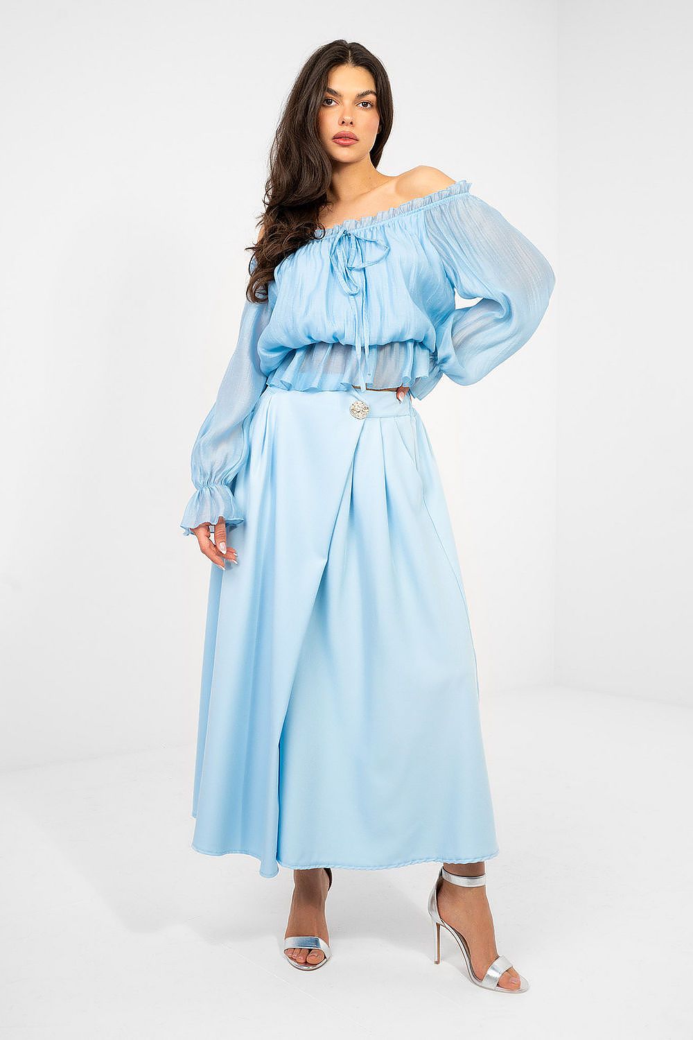 Woman wearing a light blue off-shoulder top and skirt set on a white background