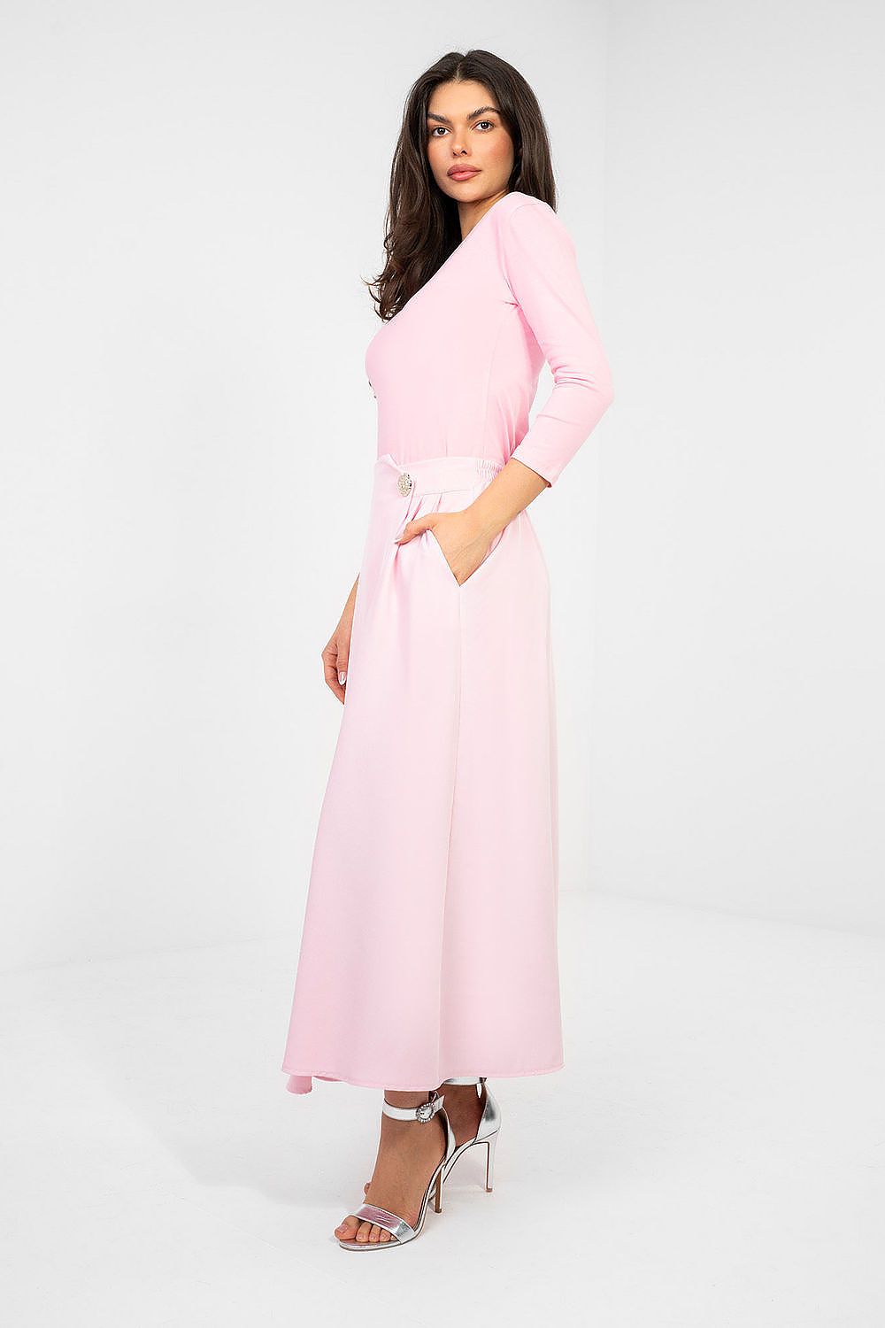 Woman wearing a pink dress on a white background