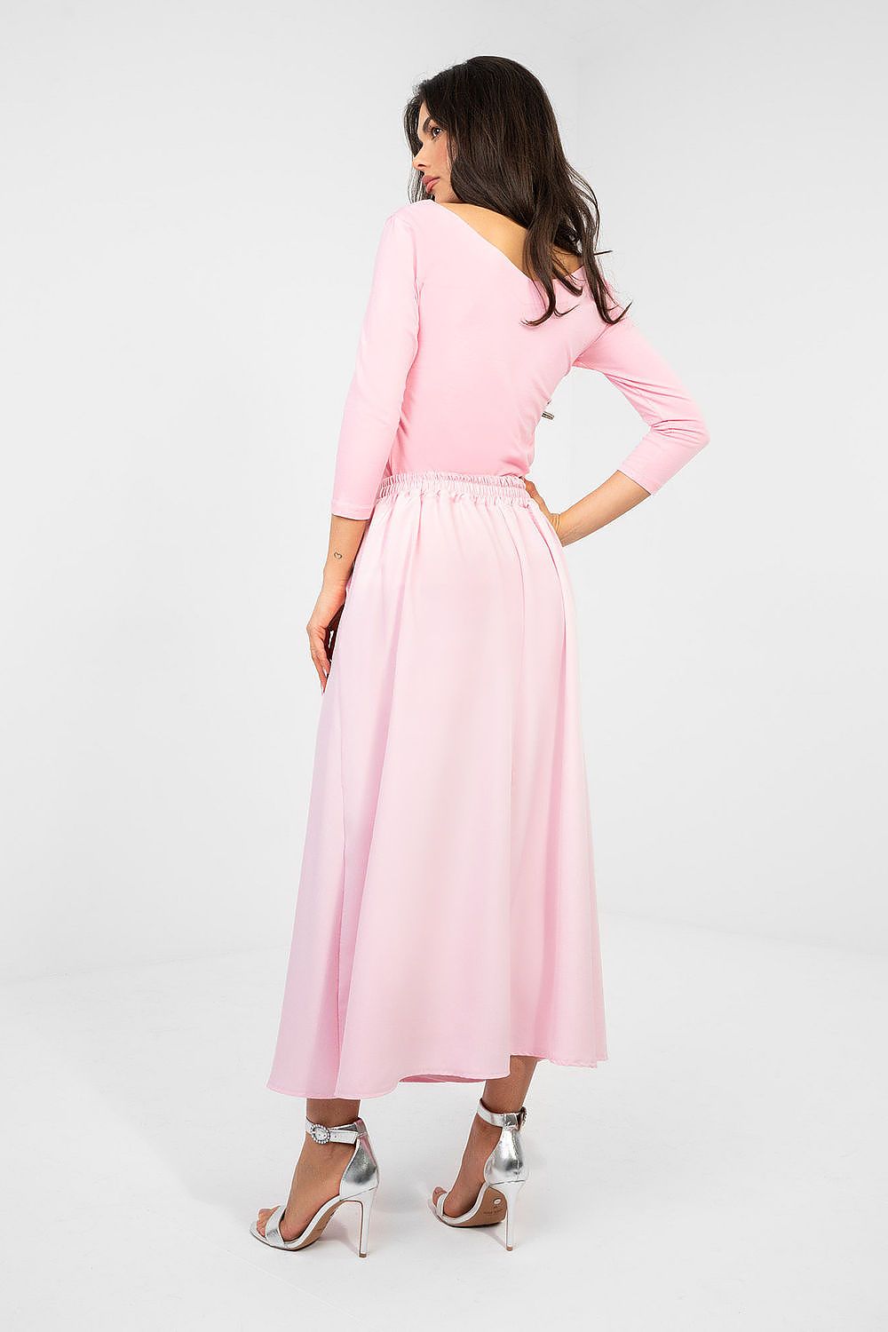 Woman wearing a pink dress on a white background