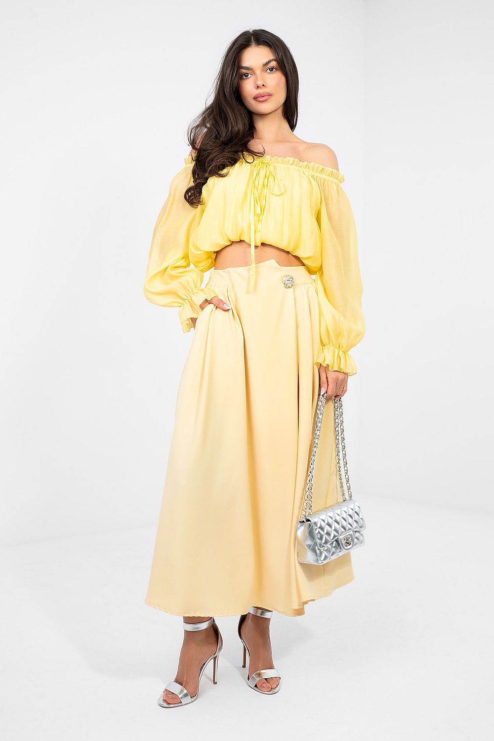 Woman wearing a yellow outfit with a white background