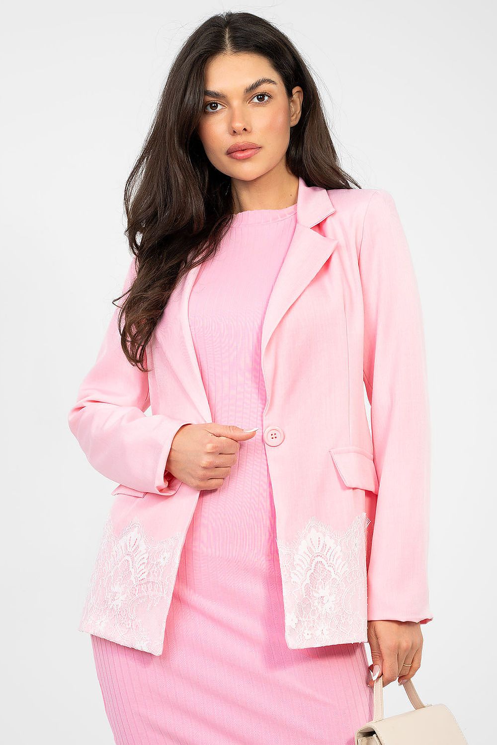 Woman wearing a pink suit with a white background