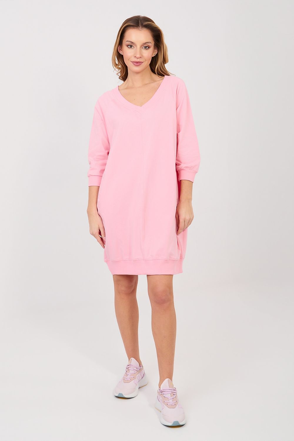 Woman wearing a pink dress on a white background