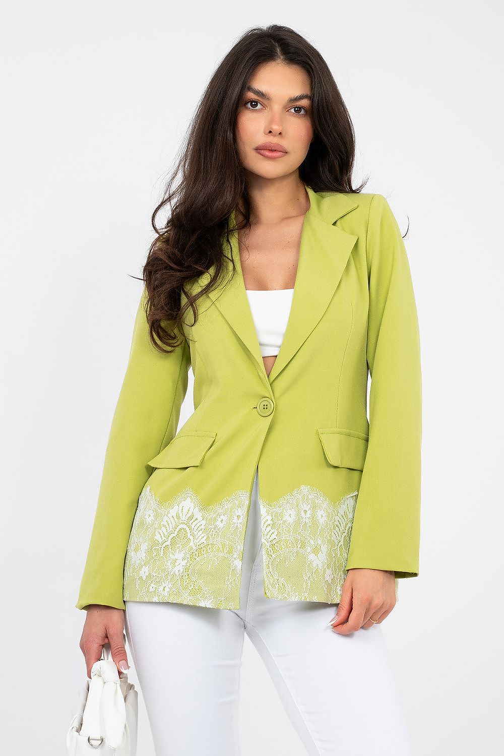 Woman wearing a green blazer with floral details on a white background