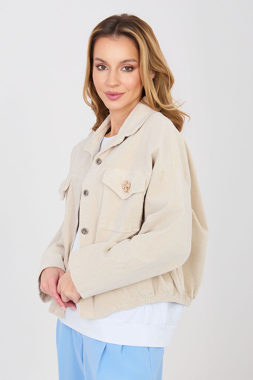 Woman wearing a beige jacket on a white background