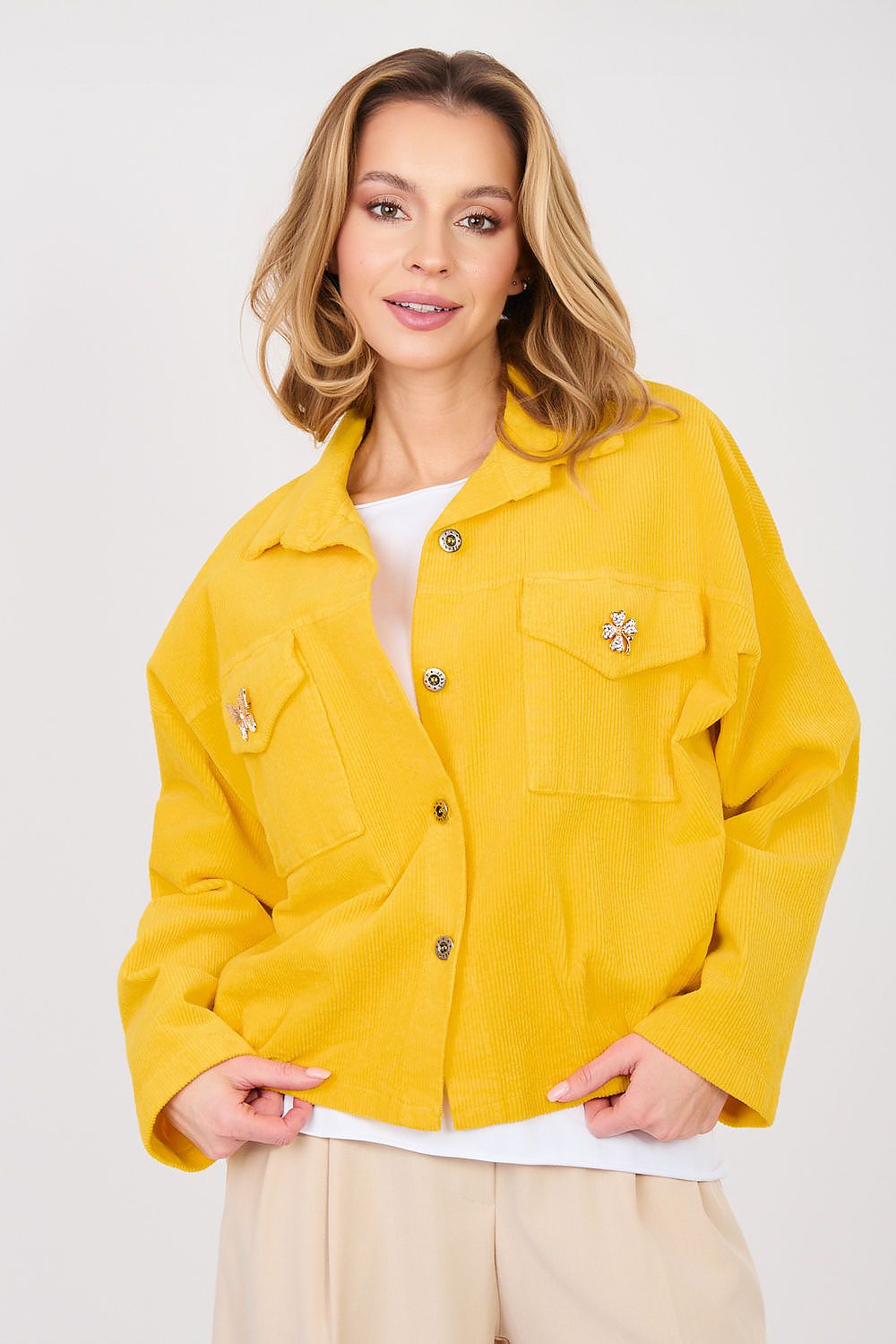 Woman wearing a yellow jacket on a white background
