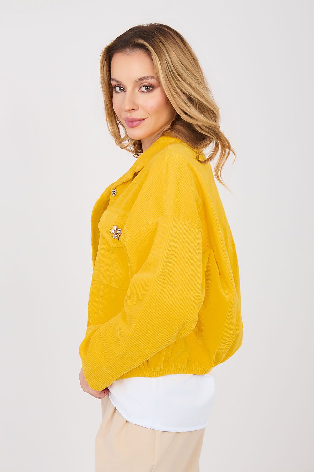 Woman wearing a yellow jacket on a white background