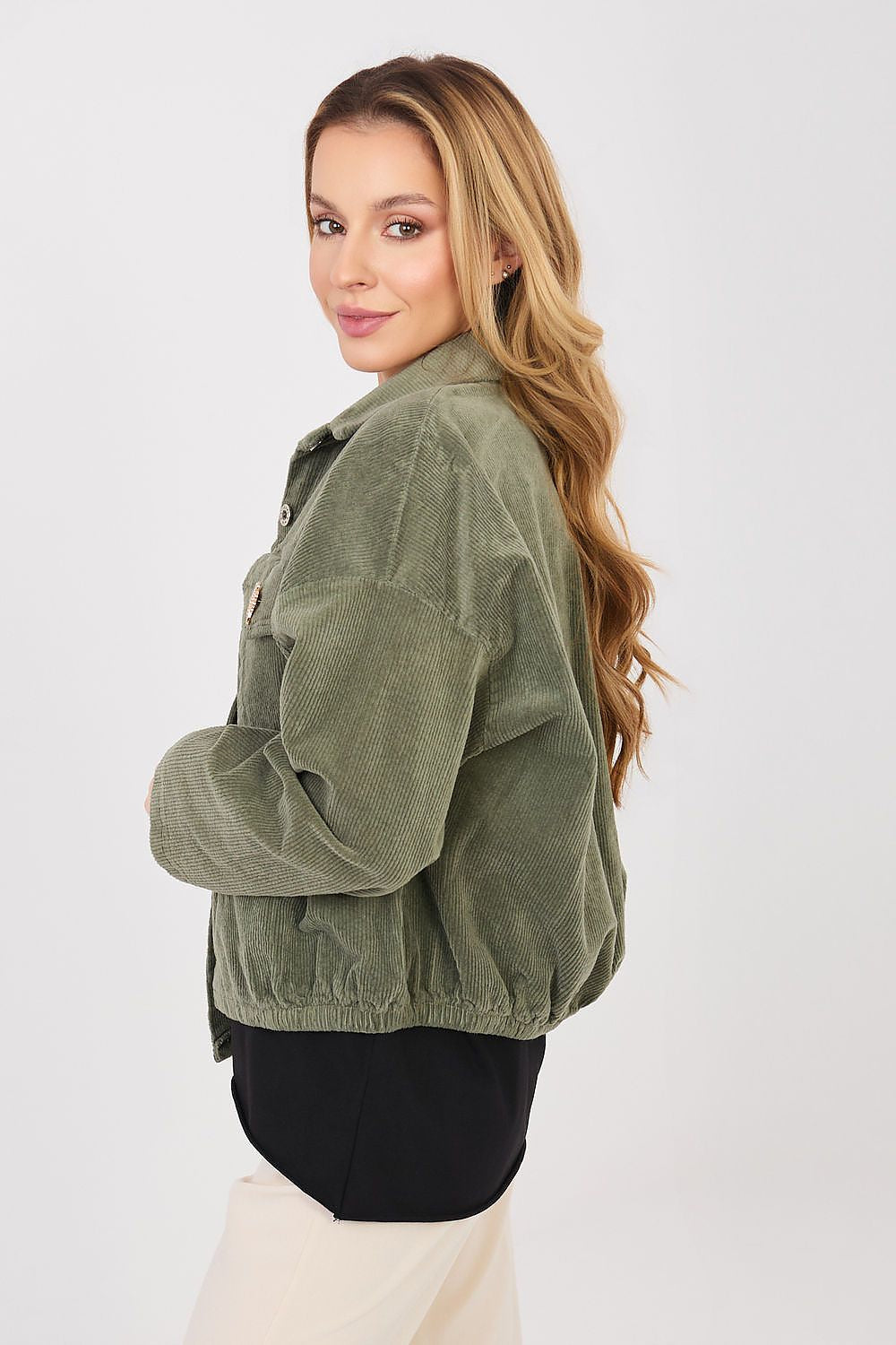 Woman wearing an olive green jacket on a white background