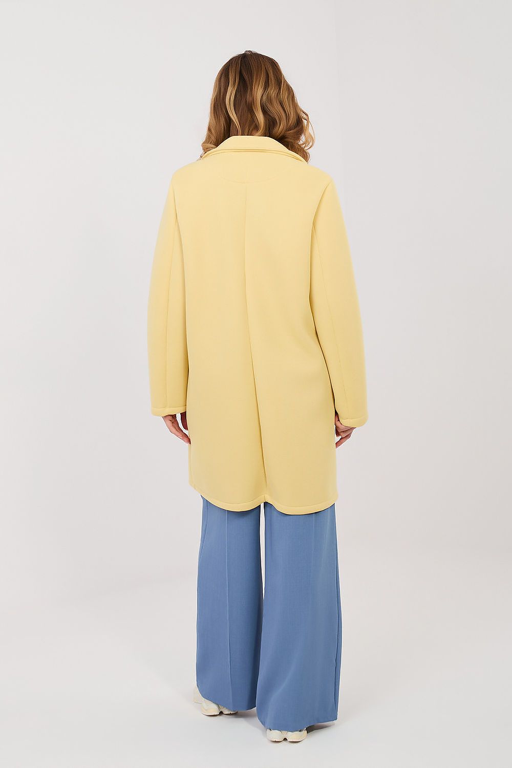  yellow elegant coat with lapels and decorative brooch rear-view