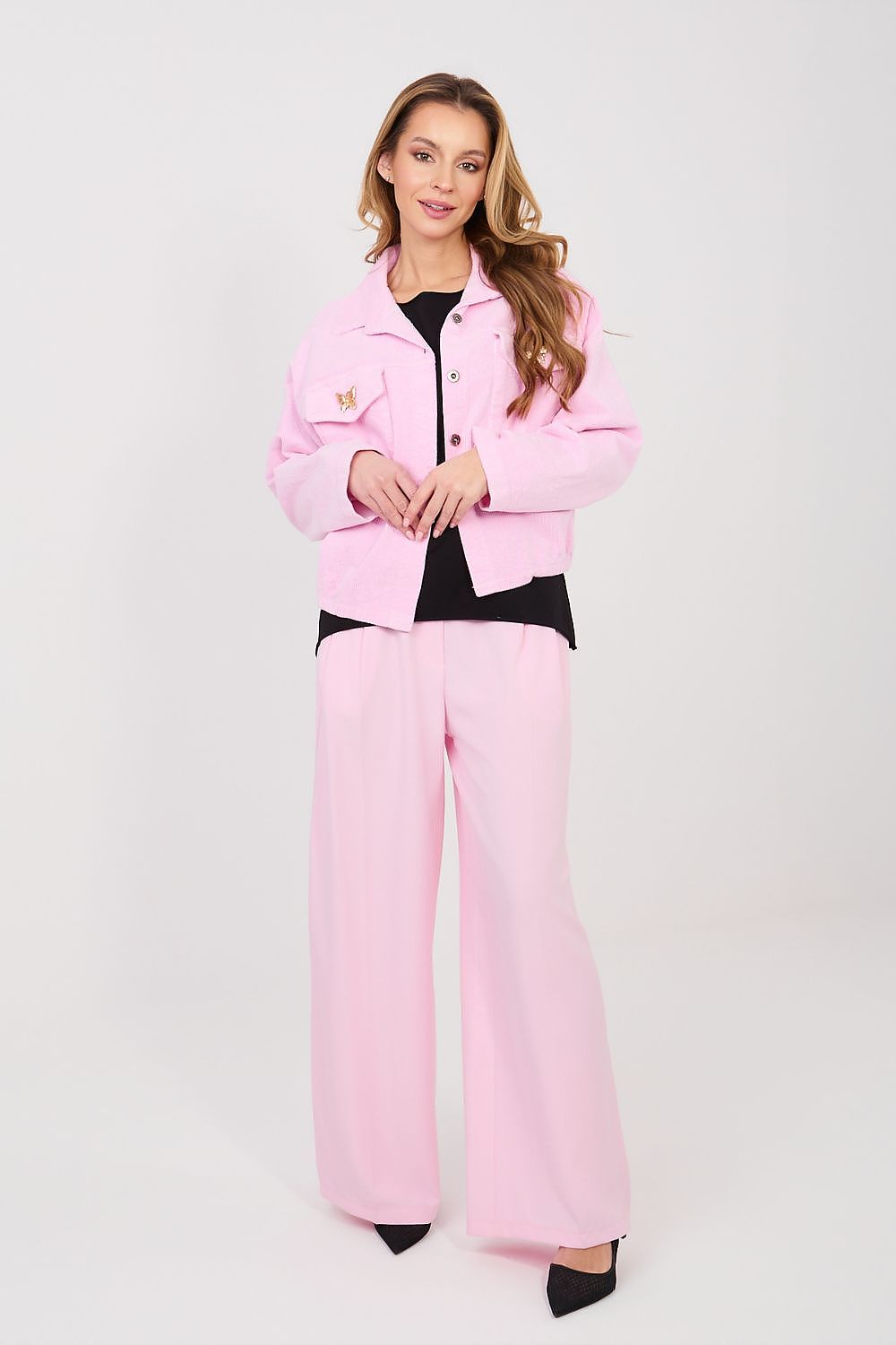 Woman wearing a pink outfit on a white background