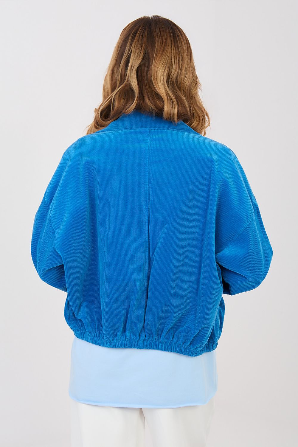 Person wearing a blue jacket on a white background