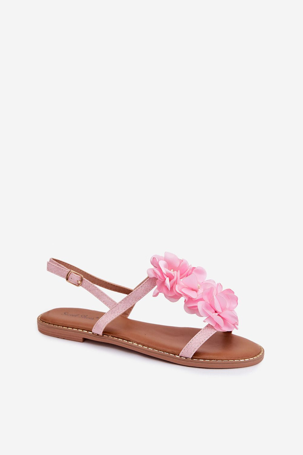 Pink sandal with floral design on a white background