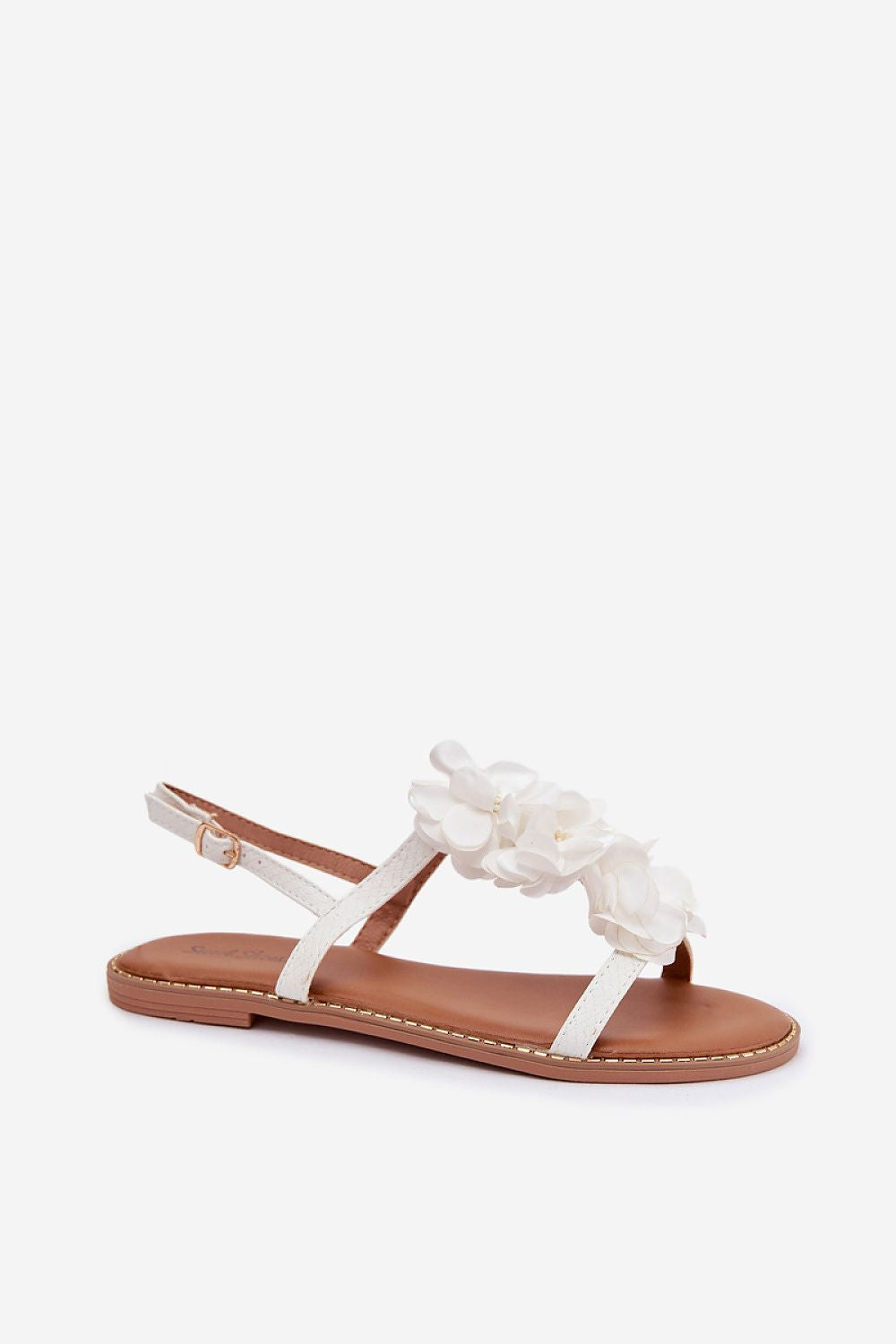White sandal with floral design on a white background