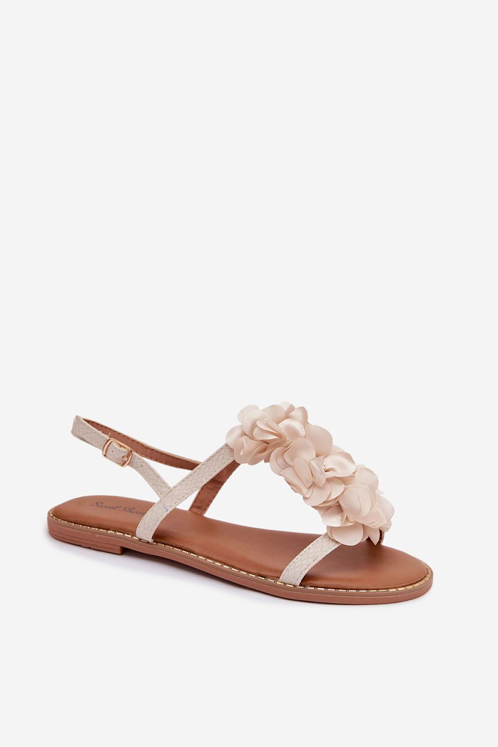 Beige sandal with floral straps on a white background