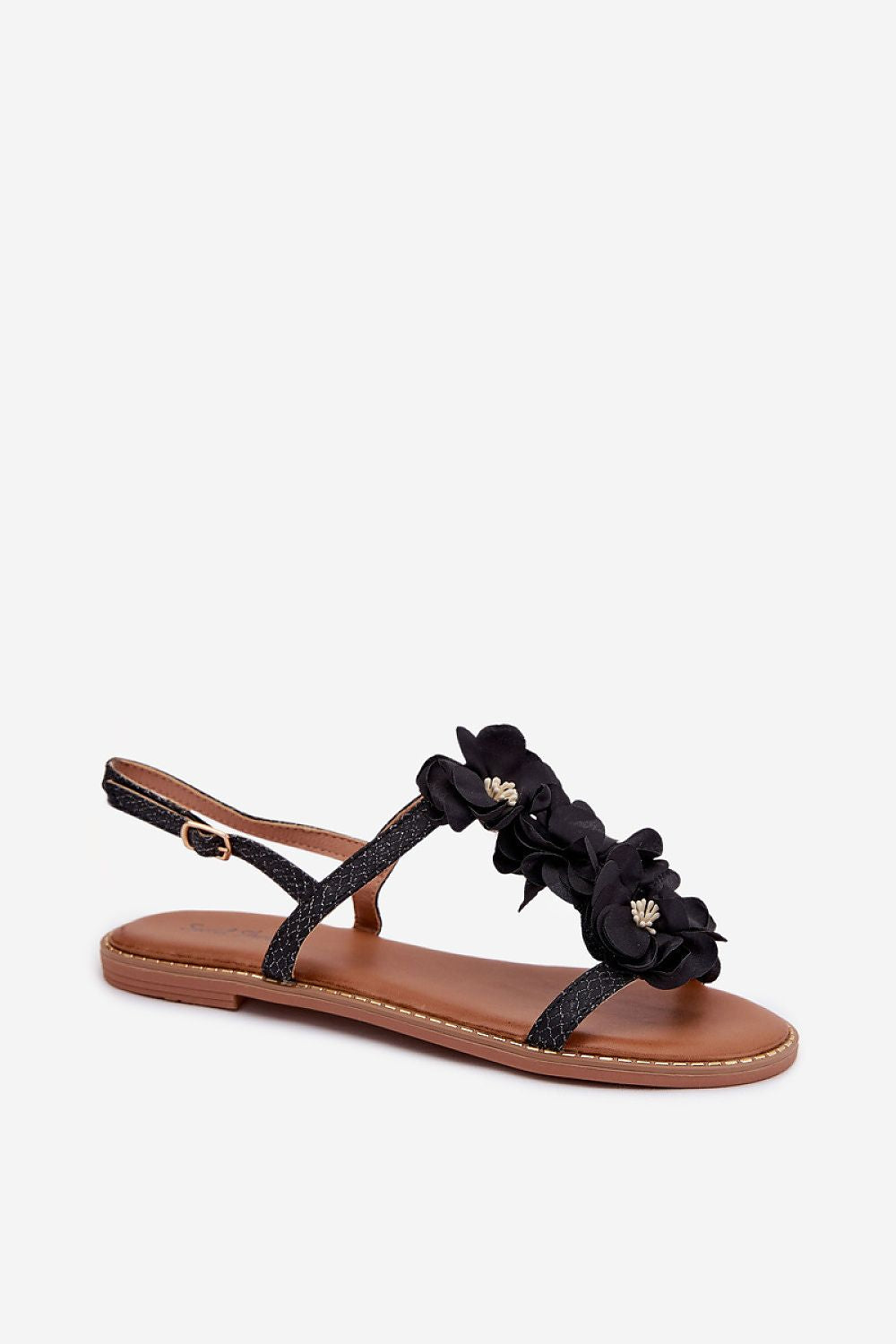 Black sandal with floral details on a white background