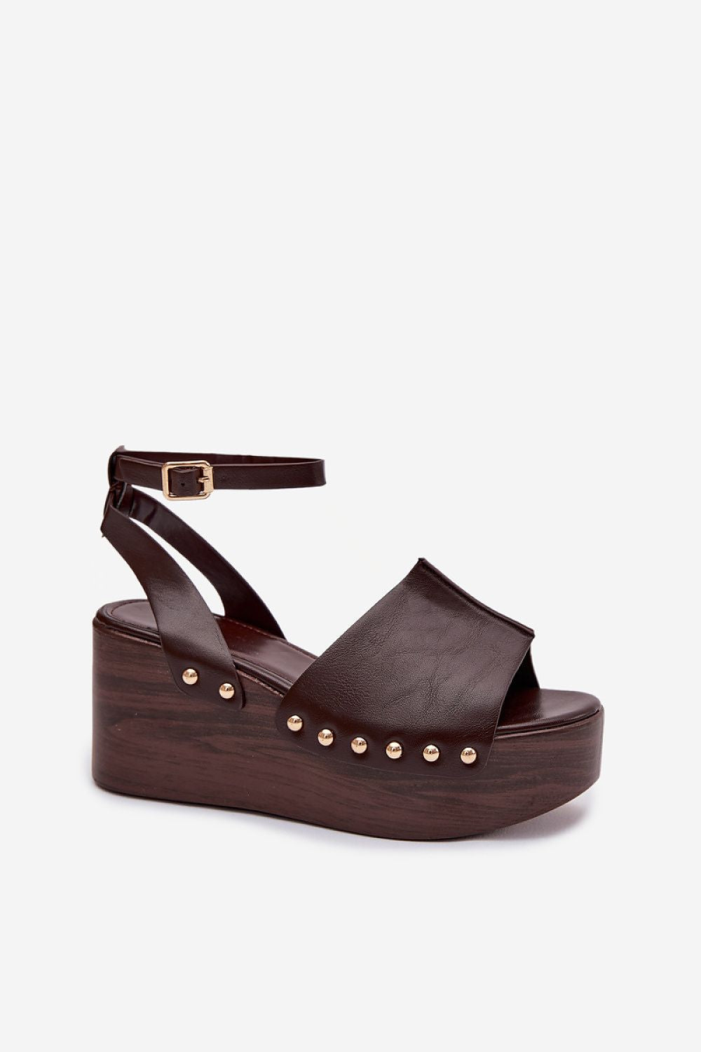 Brown platform sandal with studded details on a white background