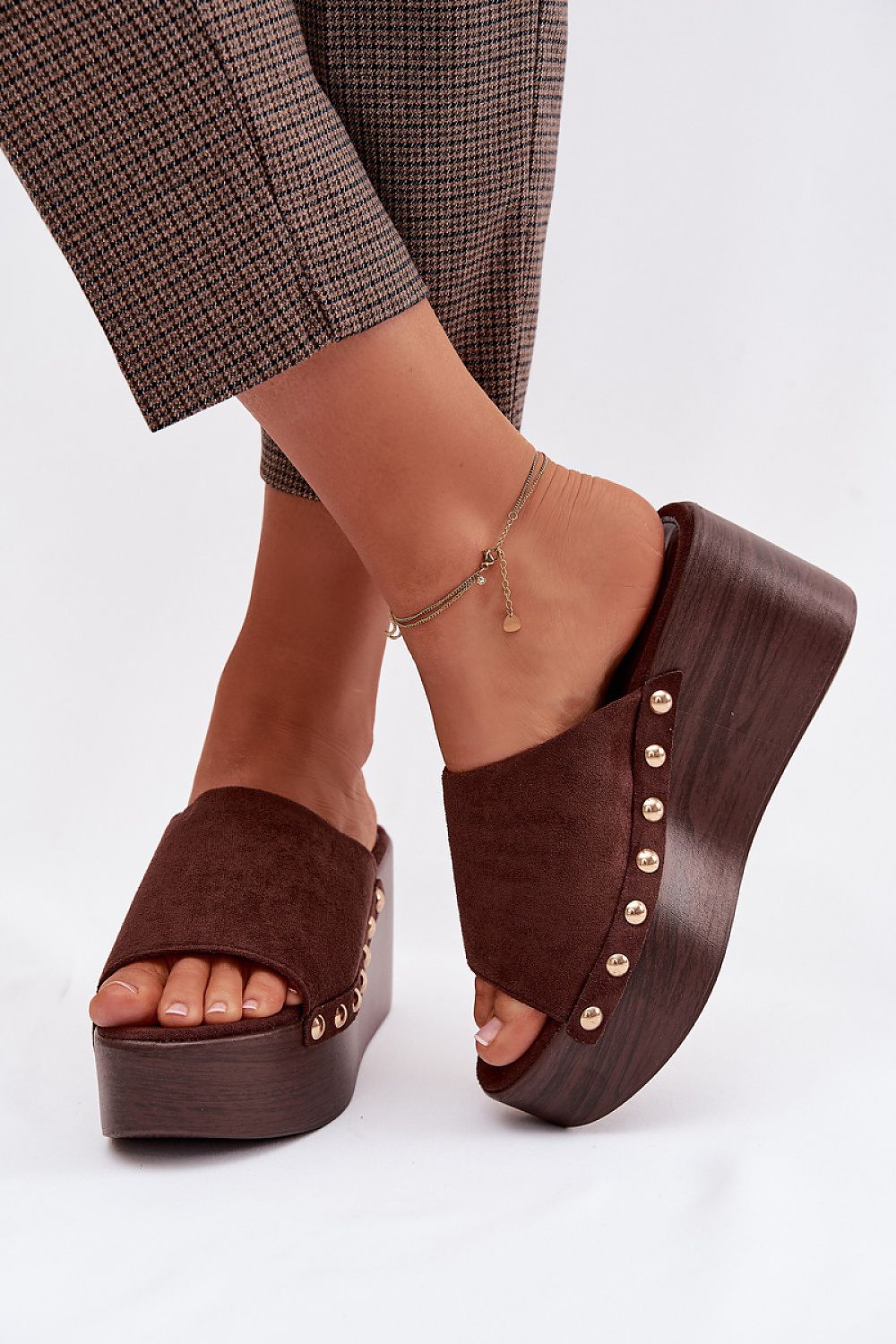 Brown suede platform sandals with wooden soles on a white background