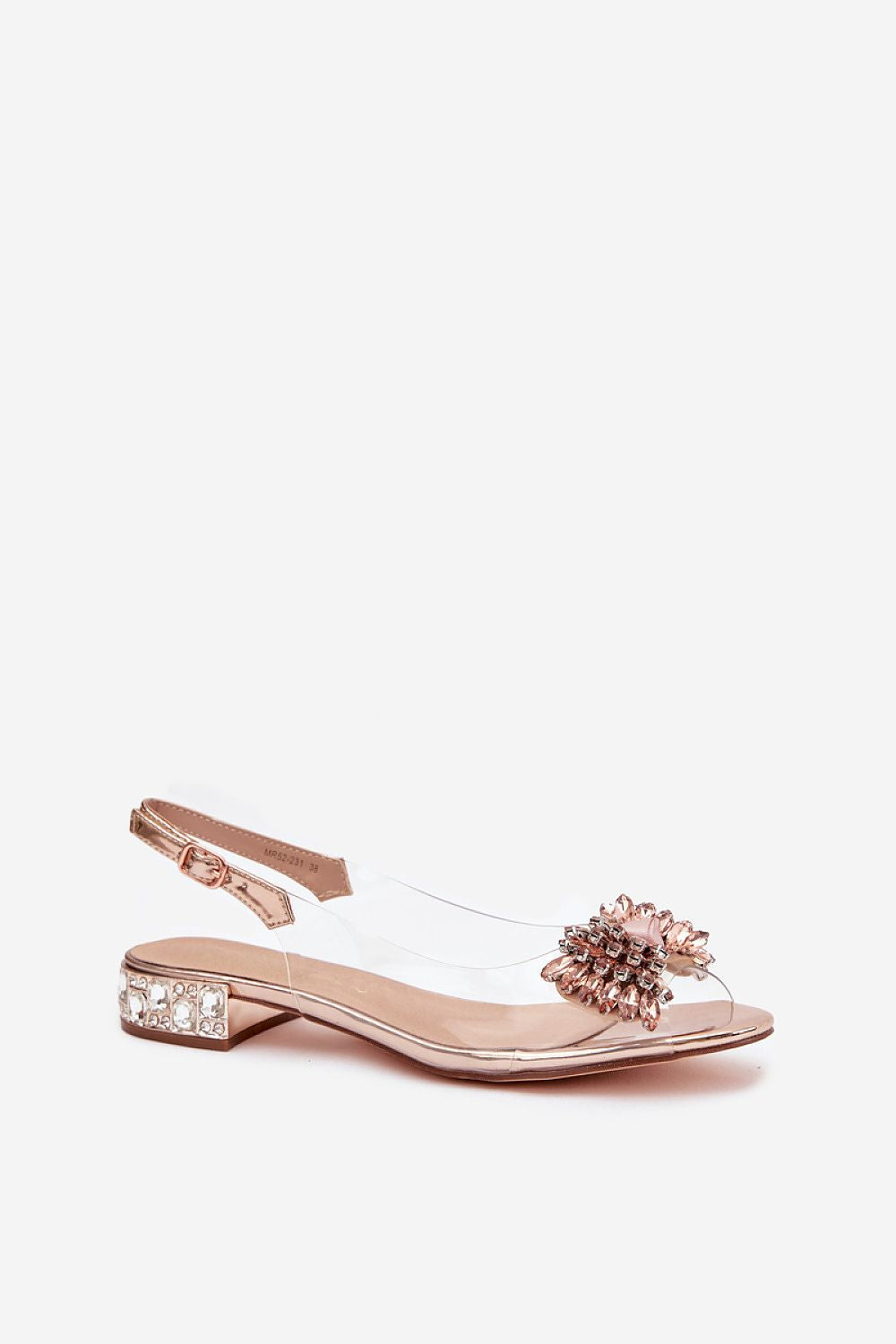Rose gold sandal with floral embellishment on a white background