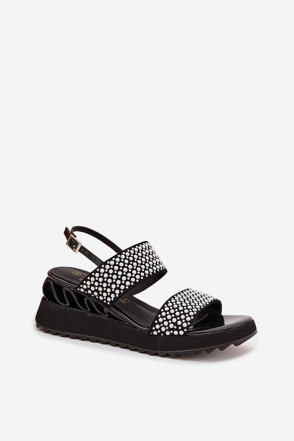 Black sandal with studded details on a white background