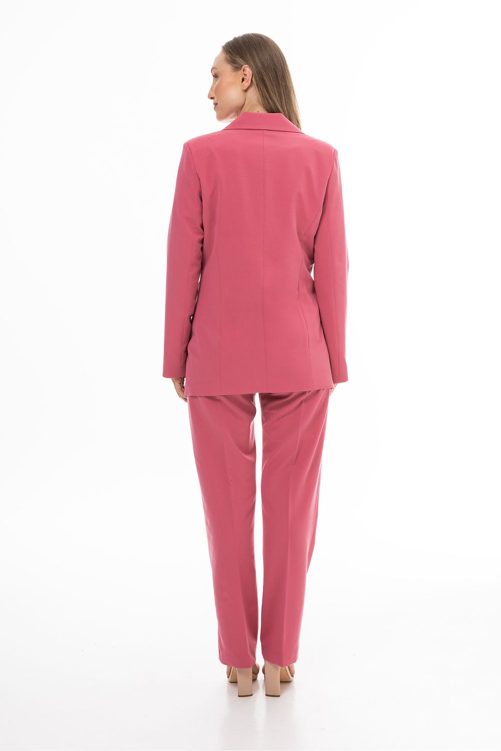 Woman wearing a pink suit on a white background