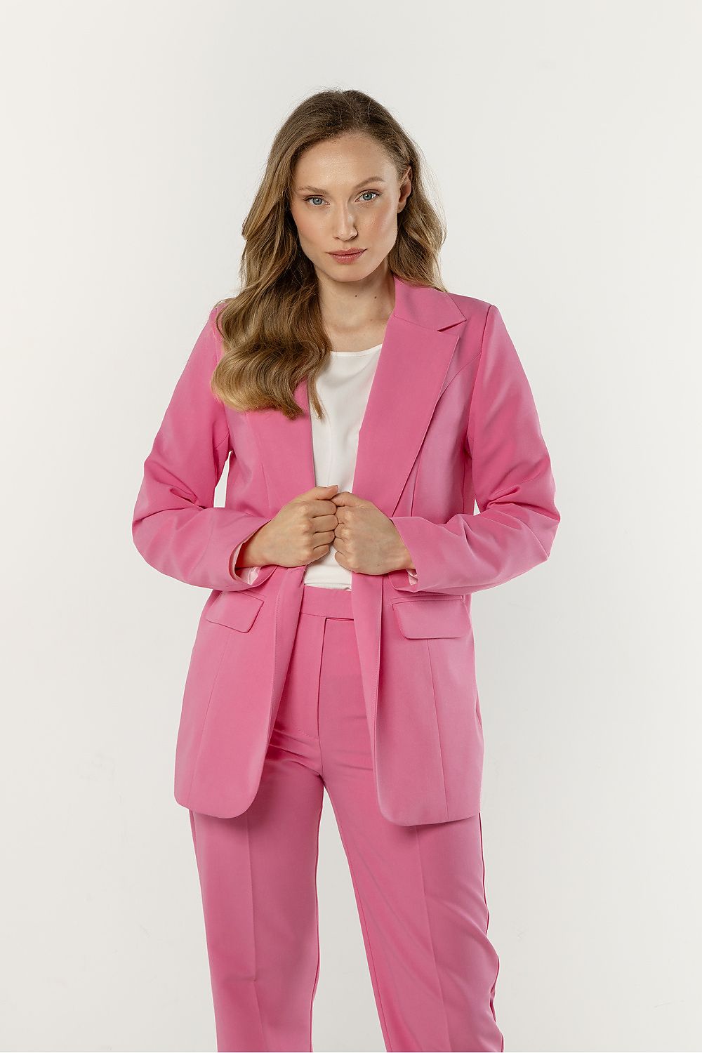 Woman wearing a pink suit on a white background