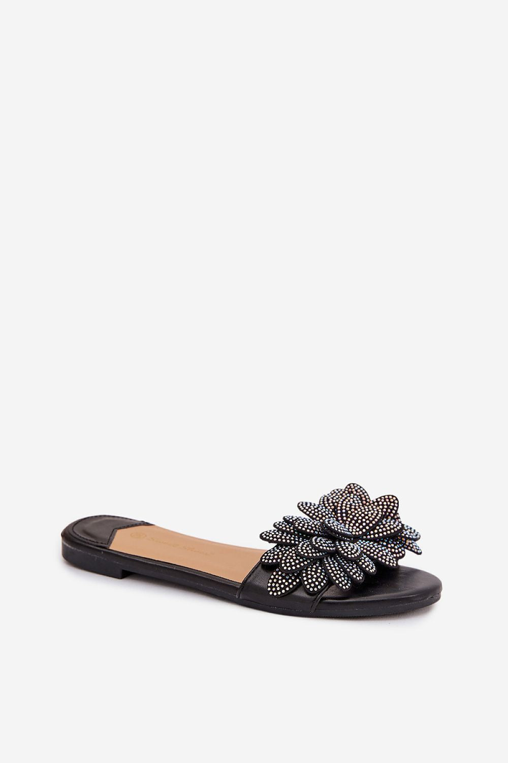 Black sandal with a decorative flower on a white background