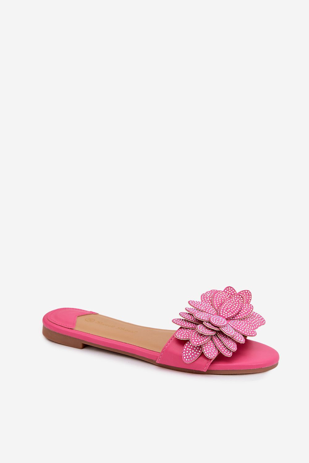 Pink flat sandal with a decorative flower on a white background