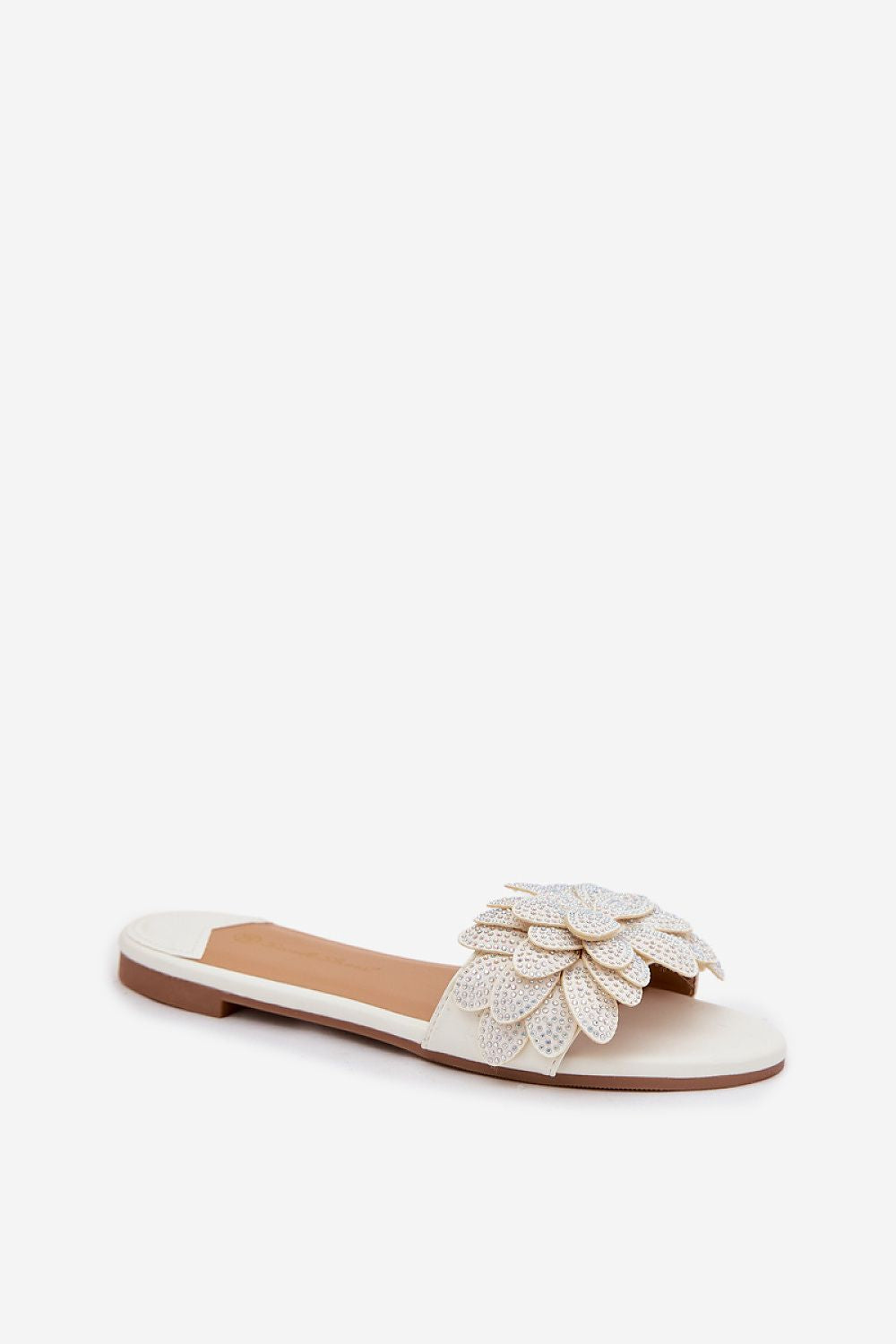 White sandal with decorative flower on a white background
