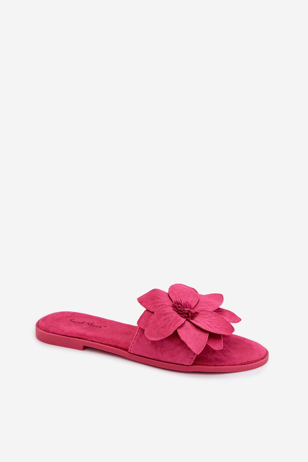 Pink sandal with a flower detail on a white background