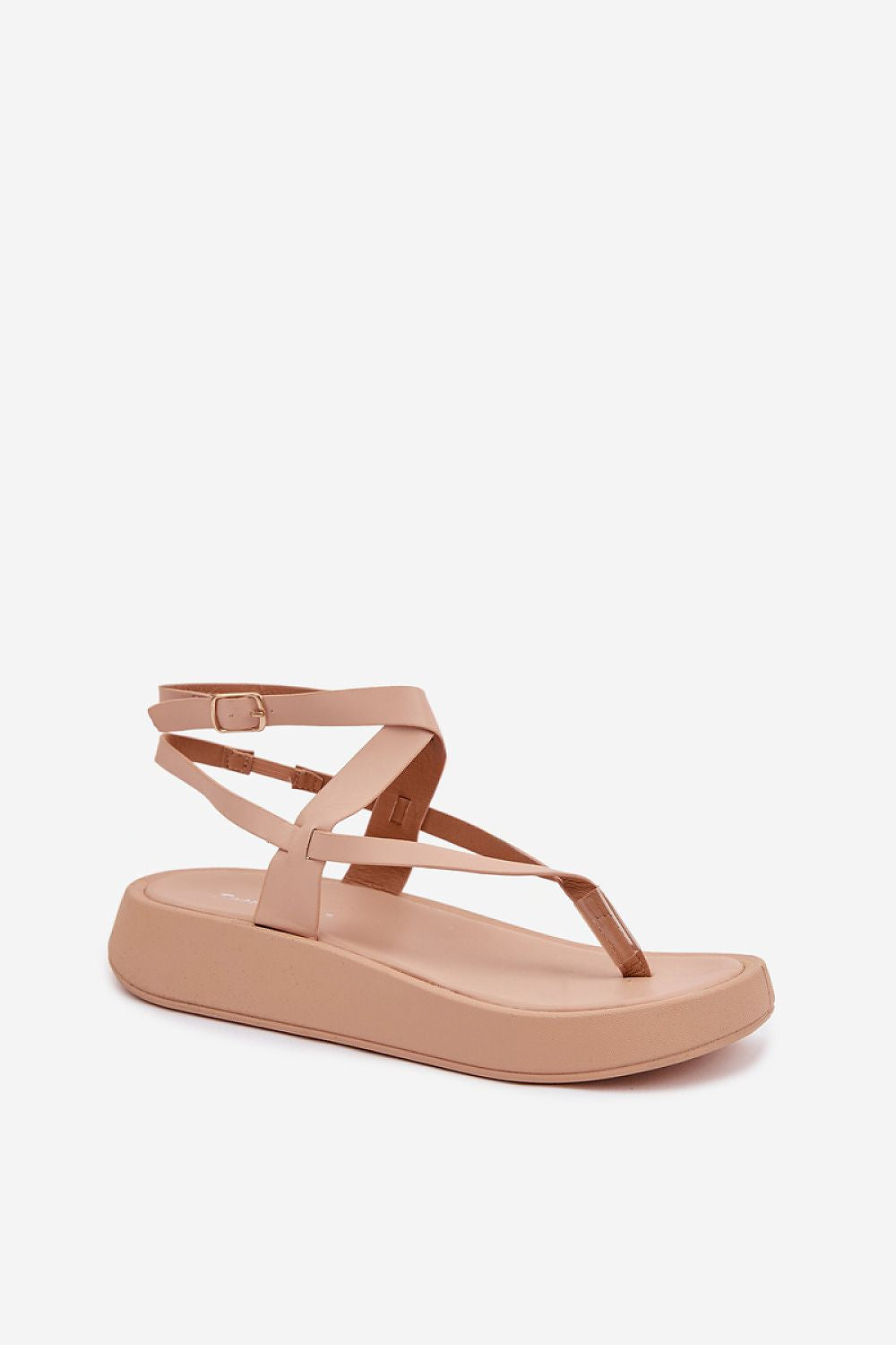 Nude-colored sandal with thin straps on a white background