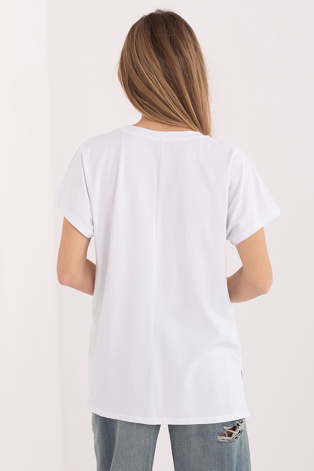 Person wearing a plain white t-shirt on a light background