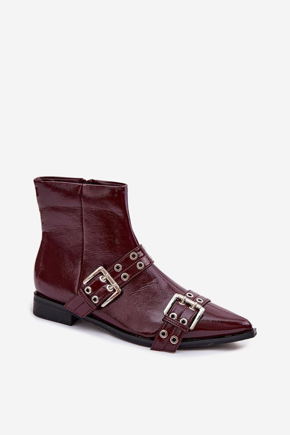 Brown leather boot with metal buckles on a white background