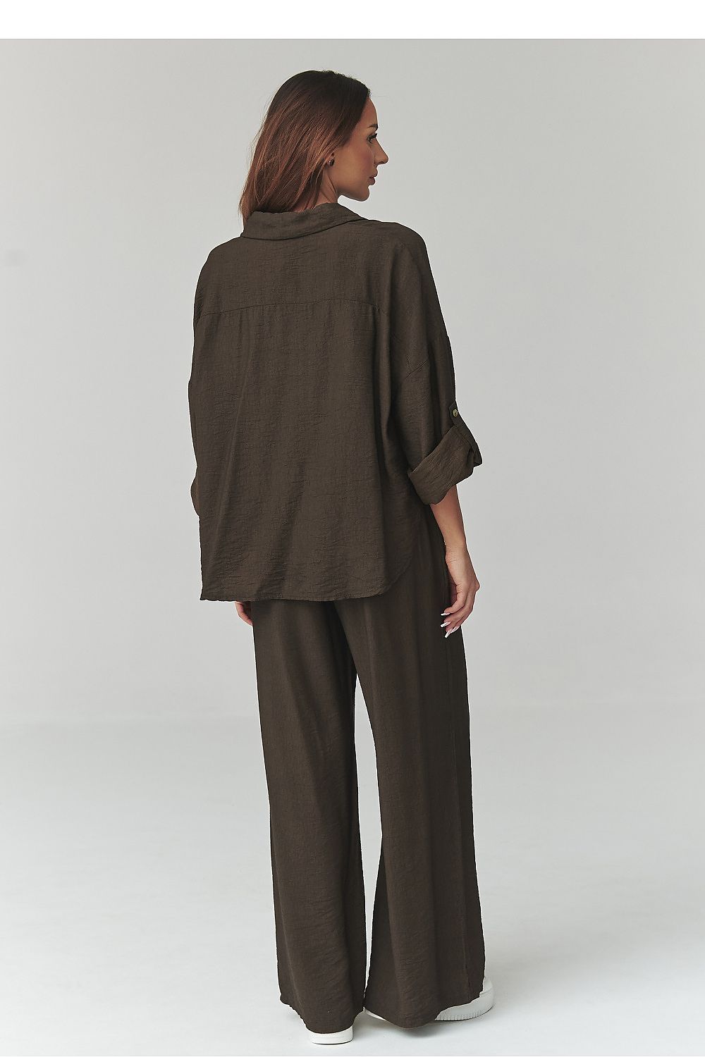 Woman wearing a brown outfit on a white background