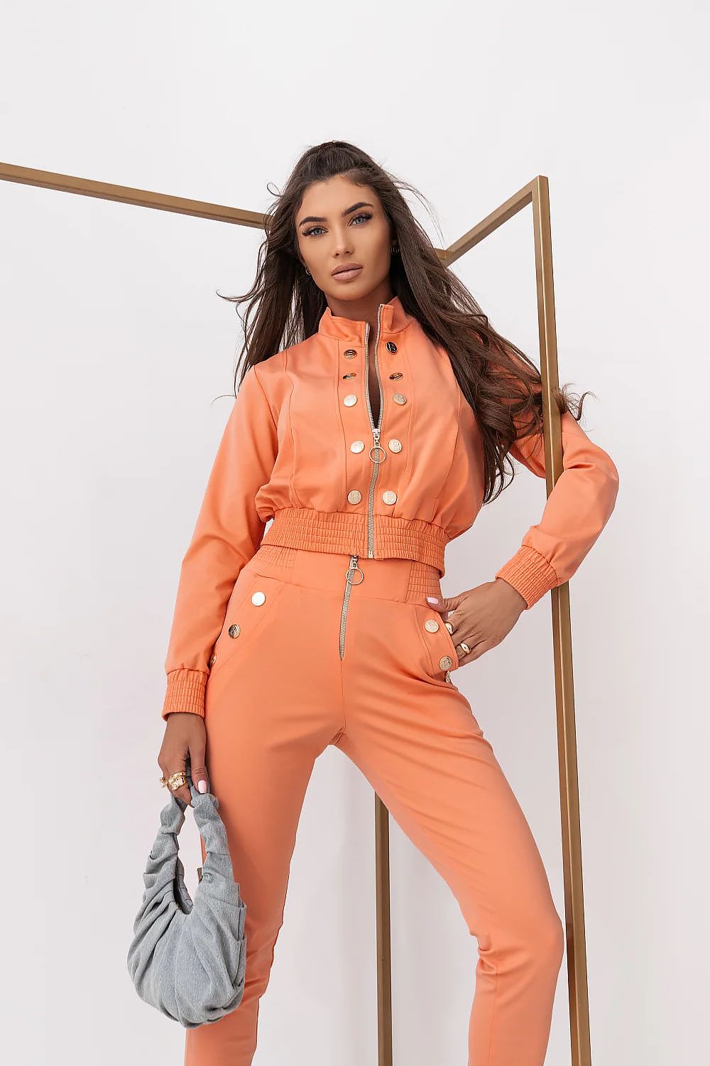 Woman wearing an orange outfit with a white background