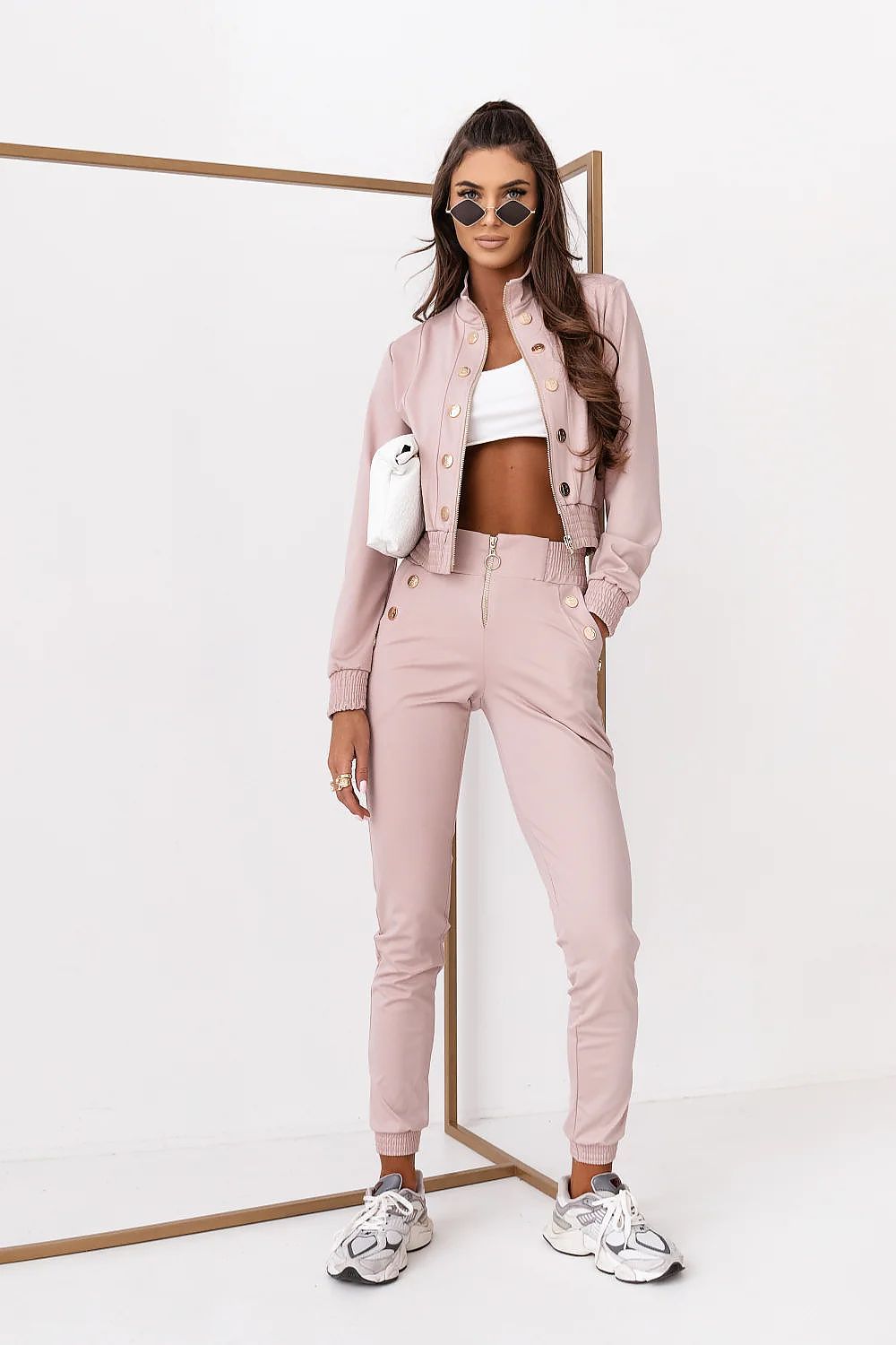 Woman wearing a pink outfit with a white background