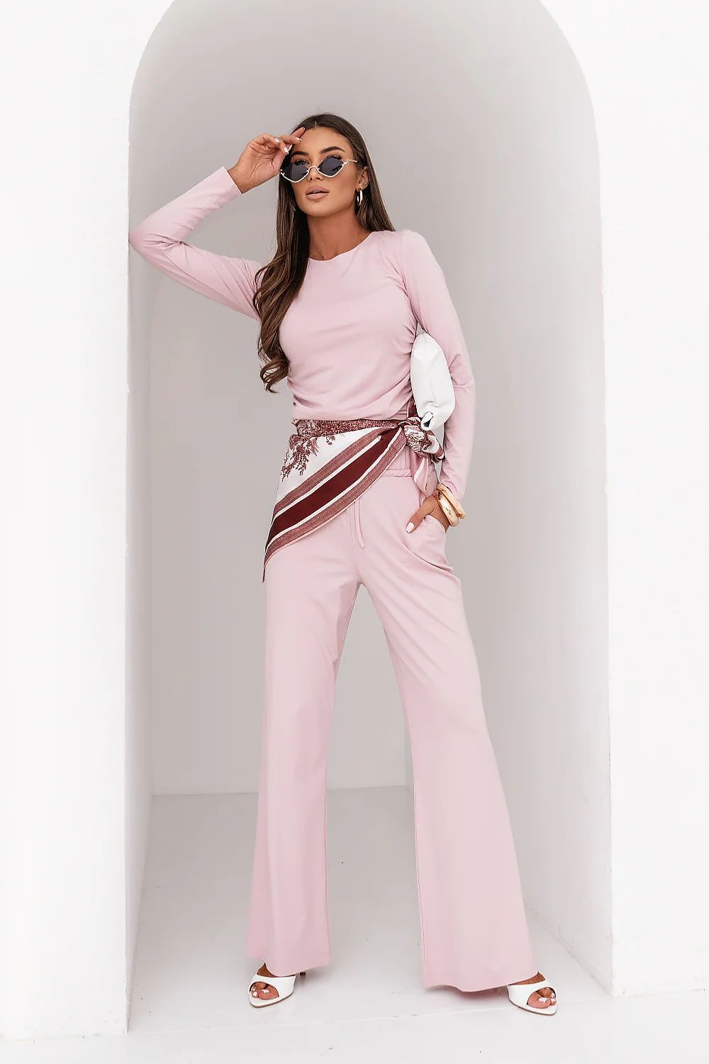 Woman in a pink outfit with a white background