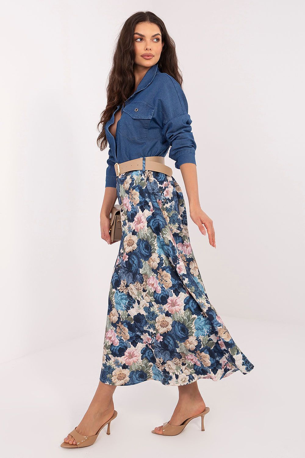 Woman wearing a blue floral dress with a white background