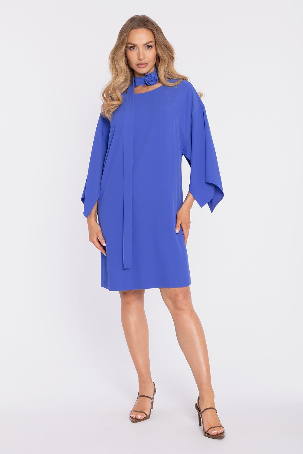 Woman wearing a blue dress with a plain background
