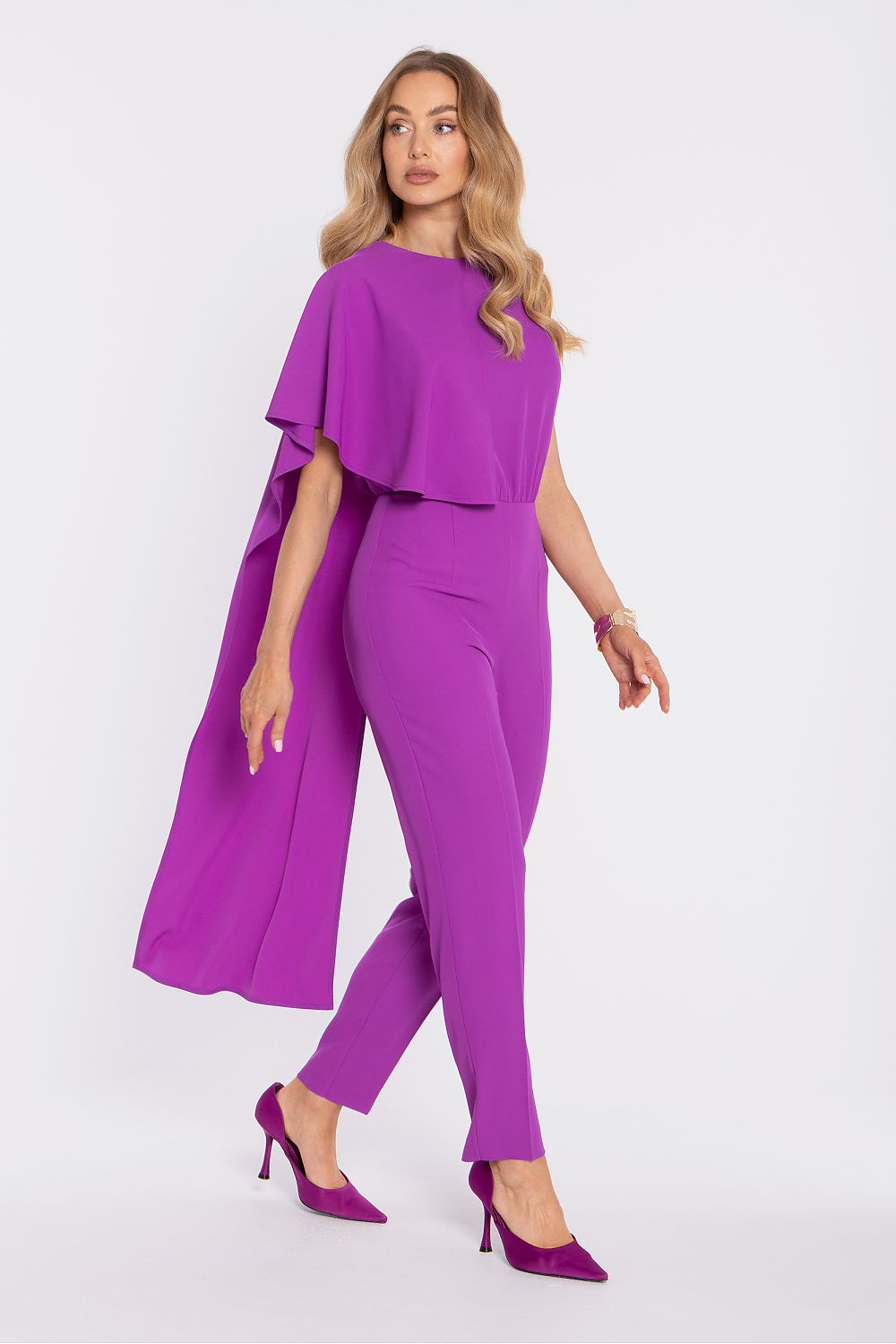 Woman wearing a purple outfit with a cape on a white background