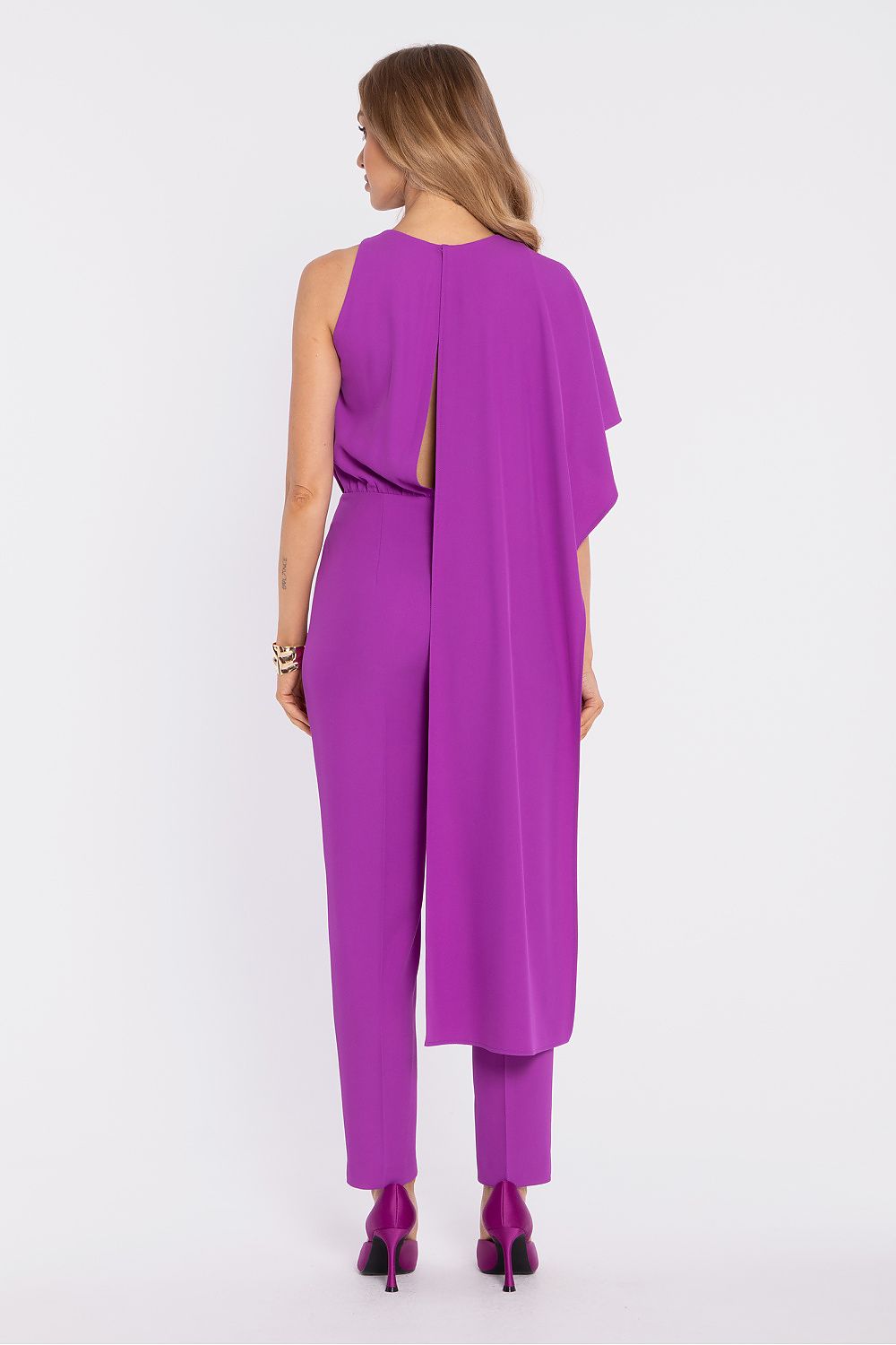 Woman wearing a purple jumpsuit on a white background