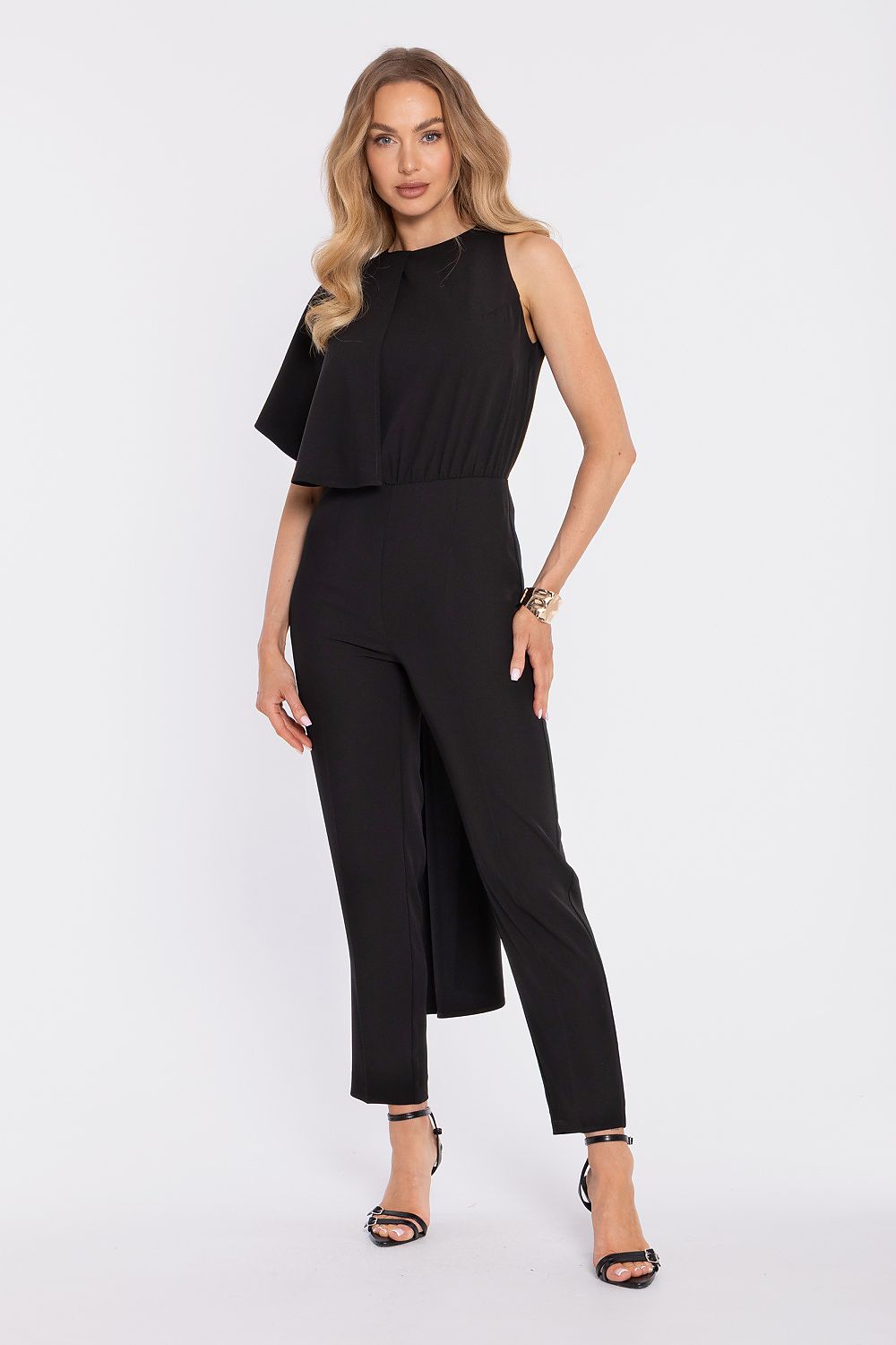 Woman wearing a black jumpsuit on a white background