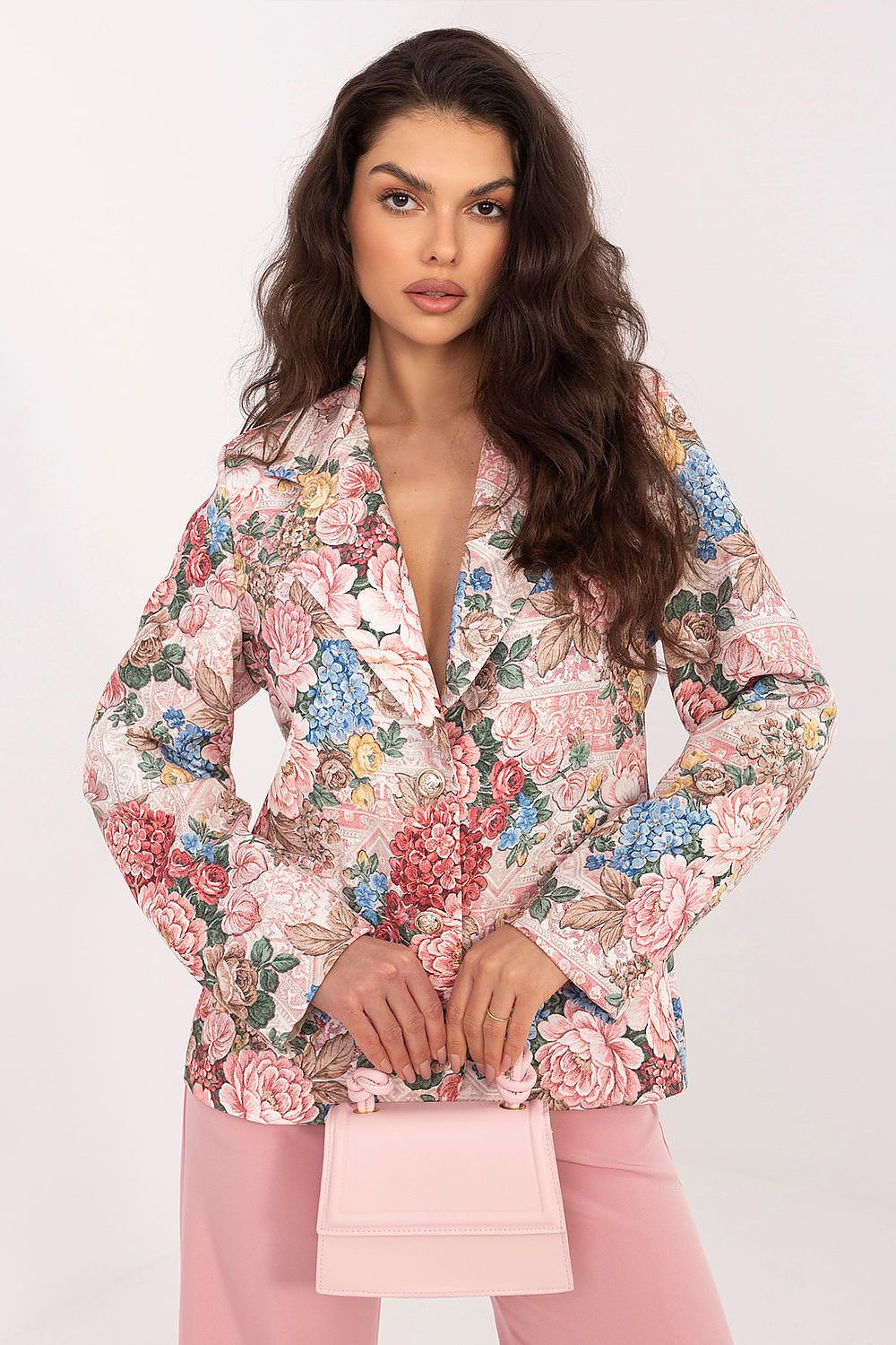 Woman wearing a floral blouse with a plain background