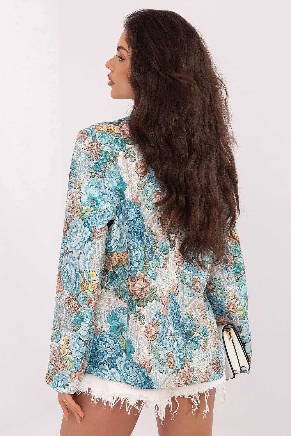 Woman wearing a floral jacket with a white background